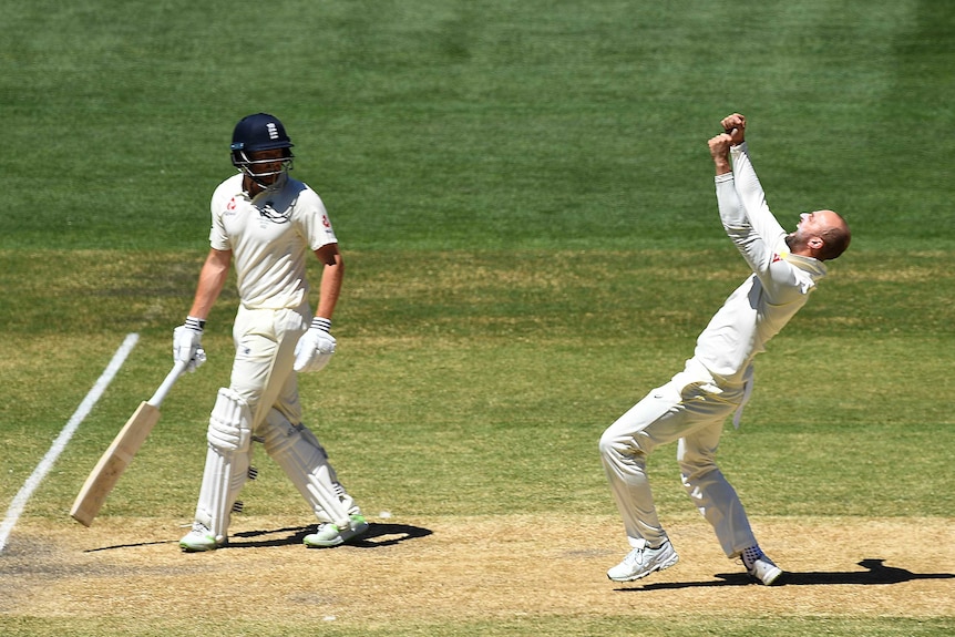 Nathan Lyon pumps his fists after dismissing Moeen Ali, as Jonny Bairstow looks on.