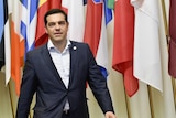 Greek prime minister Alexis Tsipras arrives to speak to journalists