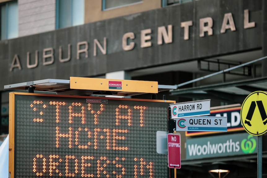 a neon sign outside as shopping centre