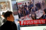A man watches a TV broadcasting a news report on a high-level talks between the two Koreas.