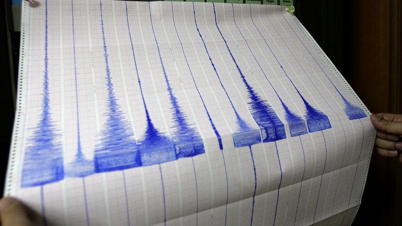 A seismologist looks at an earthquake reading