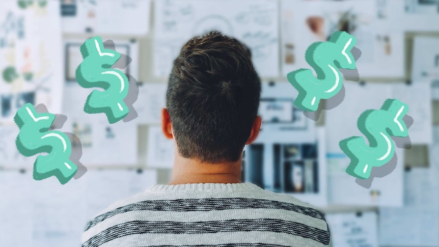 Back of a man's head as he looks at a wall covered in notes