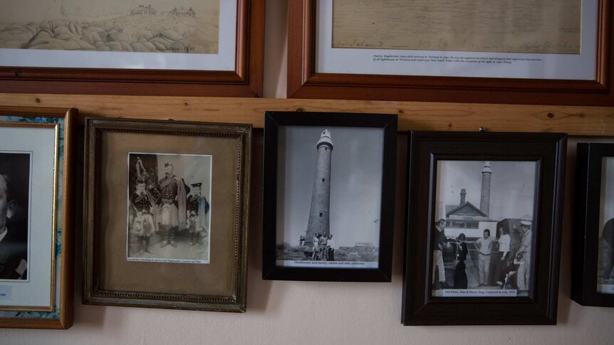 Black and white photos of previous lighthouse keepers fill the walls of the weather room.