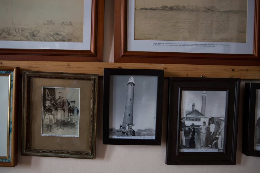 Black and white photos of previous lighthouse keepers fill the walls of the weather room.