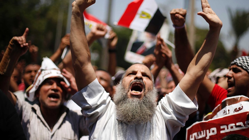 Protesters chant slogans during a rally near Cairo University