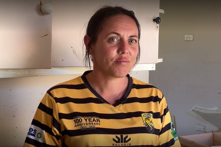 profile photo of a woman wearing a yellow and black football jersery