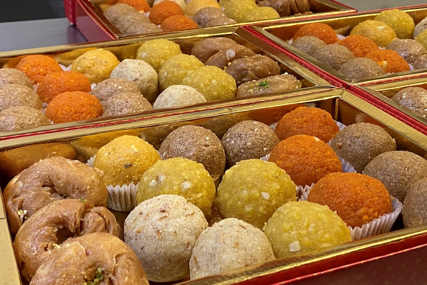 A box of colourful, round Indian sweets known as laddu.