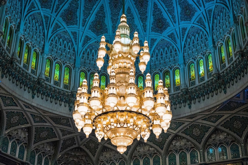 A chandelier hanging underneath a dome.