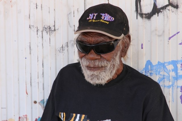 An Aboriginal man in cap and dark glasses