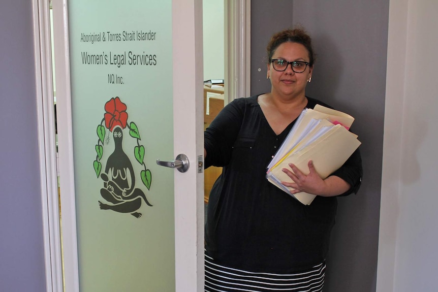 A young Indigenous woman opens the door to the Aboriginal and Torres Strait Islander Women's Legal Service