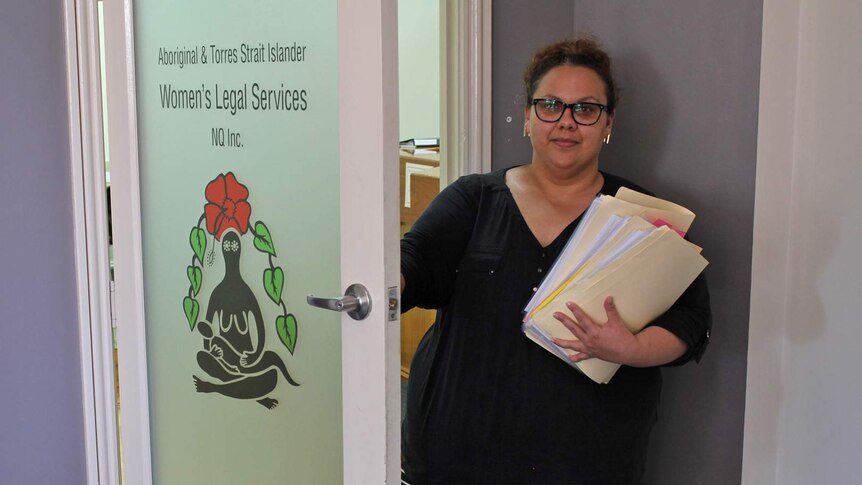 A young Indigenous woman opens the door to the Aboriginal and Torres Strait Islander Women's Legal Service