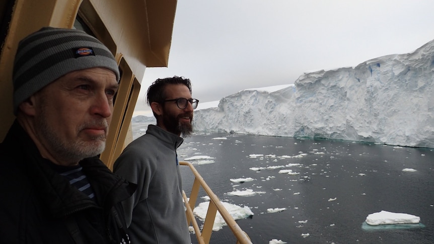 Dr Robert Larter (left) and Dr Alastair Graham look out at the face of the Thwaites Glacier from the bridge deck of the R/V Nathaniel B. Palmer.