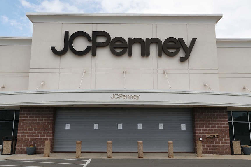 An empty carpark in front of a large JC Penney department store.