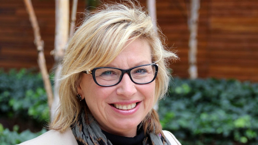 Rosie Batty smiles at the camera. She is wearing glasses.