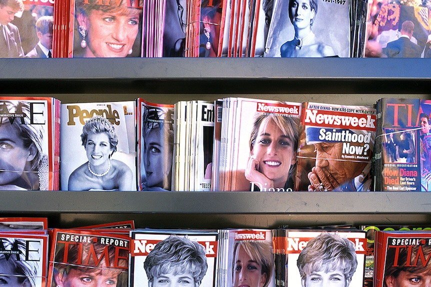 Three rows of a magazine rack lined with magazines featuring images of Princess Diana.