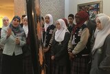 Sherene Hassan, from the Islamic Museum of Australia, shows tourists around the museum