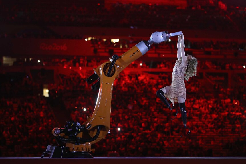 Amputee snowboarder Amy Purdy dances alongside a robotic arm at the Rio Paralympics opening ceremony