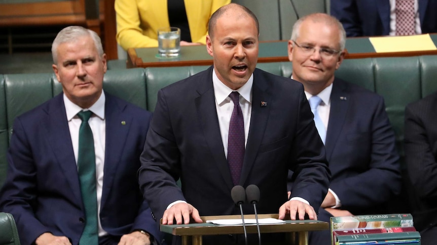 Josh Frydenberg stands at a podium in parliament delivering the federal budget on April 2, 2019.