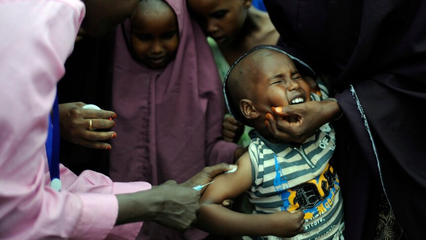 A young Somali refugee gets vaccinated at the Dadaab refugee complex.