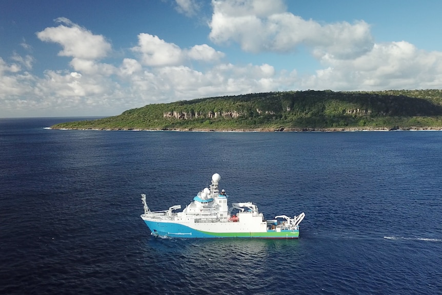 Ship and cliffs of Christmas Island from drone