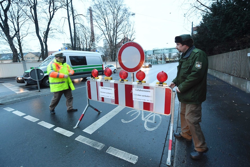 Policemen use road blocks to prevent citizens of Augsburg from getting close to the bomb site.