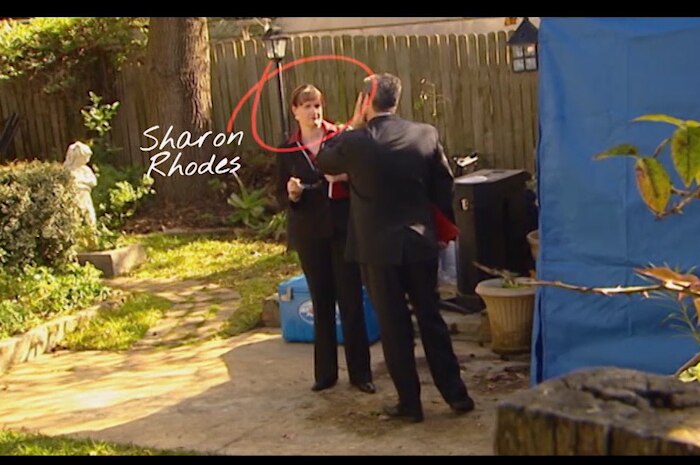 Woman wearing suit in backyard with red circle around her