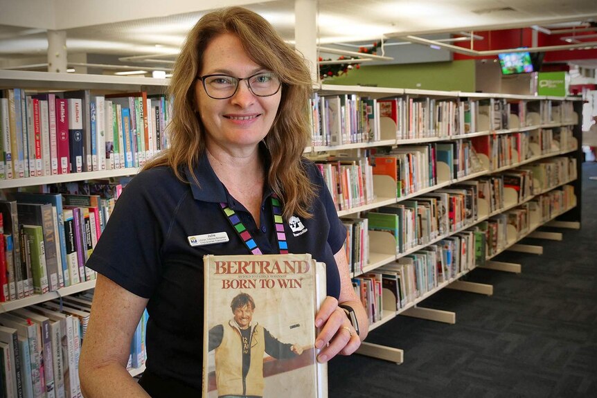 Librarian Samantha Shatte holds a well-travelled copy of Bertrand's Born to Win