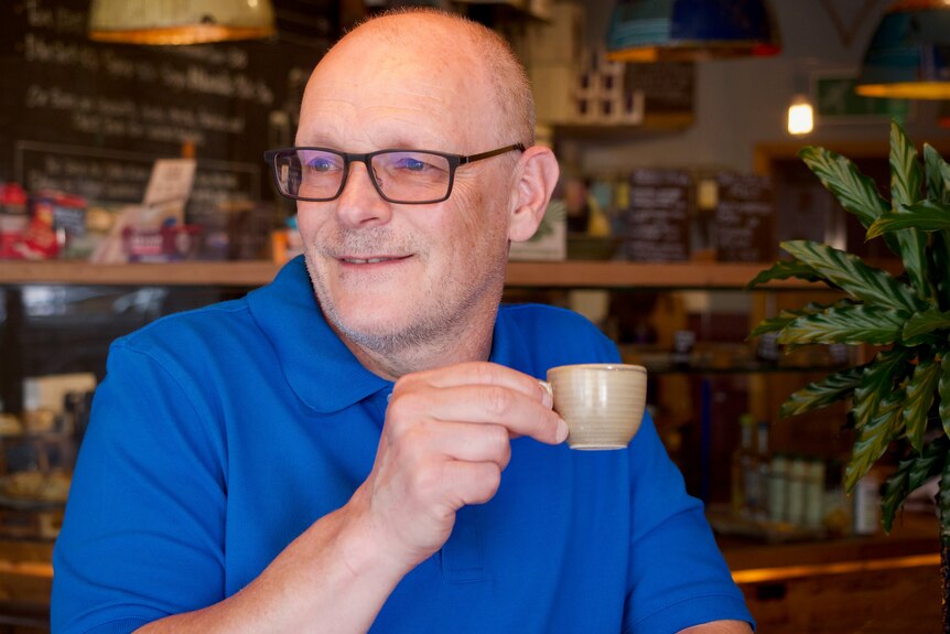 Portrait of Jonathan Morris sipping an espresso in a cafe