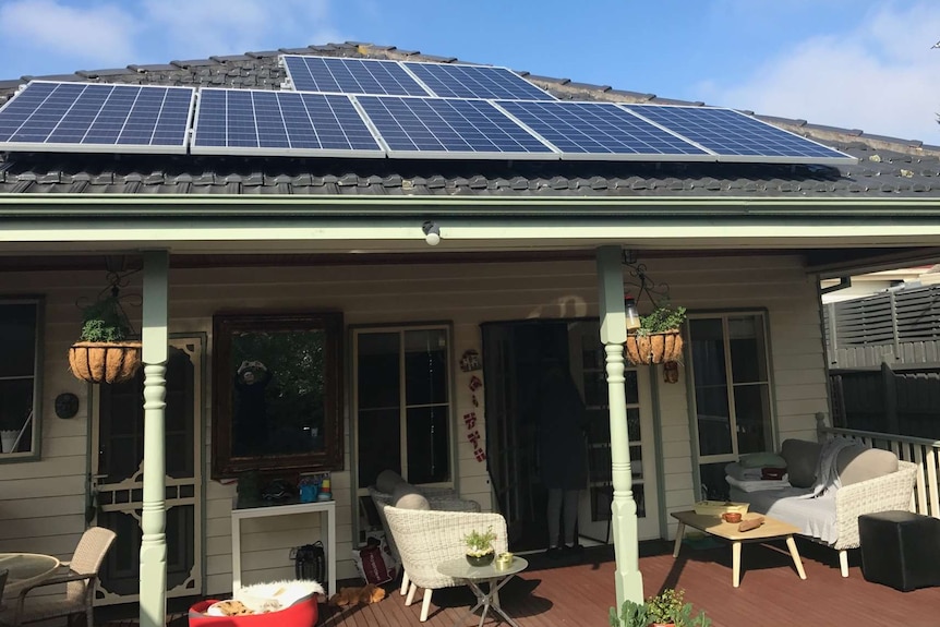 Four solar panels on the roof of a suburban home in Melbourne
