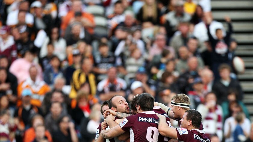 The Sea Eagles celebrate Glenn Stewart's important try late in the first half.