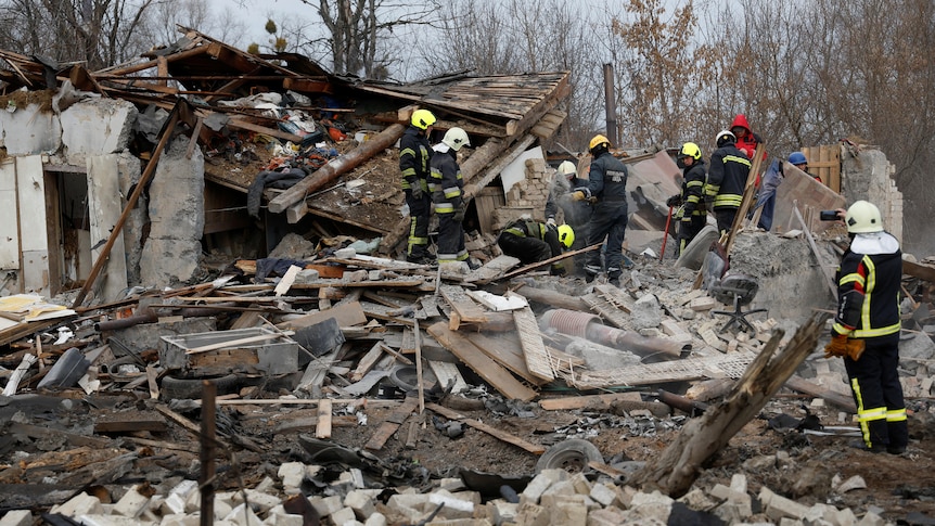 Firefighters work at a site of a residential house damaged during a Russian missile strike.