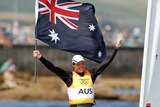 Flying the flag ... Australia's Tom Slingsby celebrates his country's first individual gold medal.