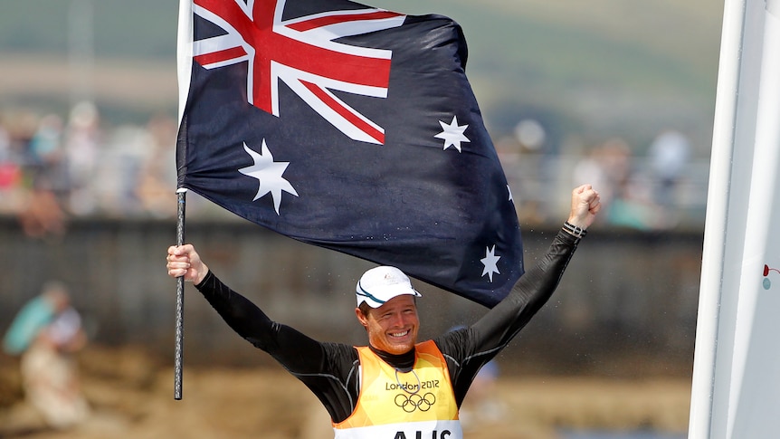 Flying the flag ... Australia's Tom Slingsby celebrates his country's first individual gold medal.