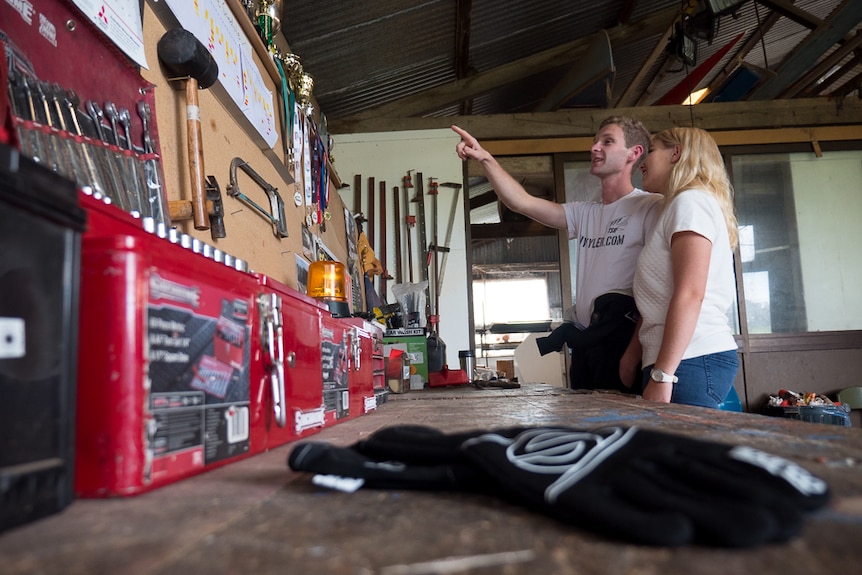 Guy Tyler and his partner Evangeline Mcallan look through his trophies.