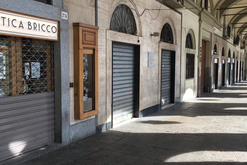 Closed stores on a Turin pizazza.