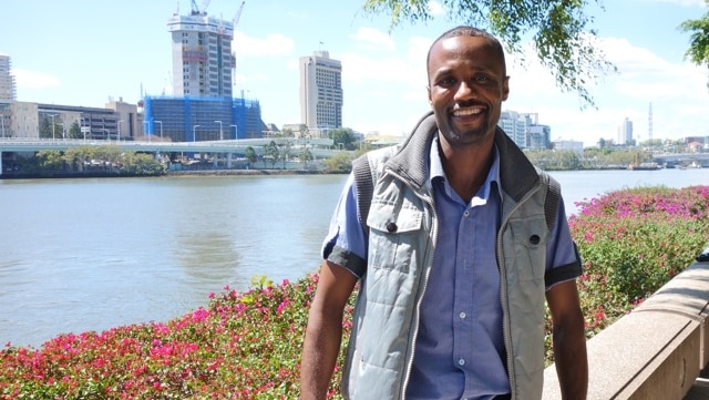 Man stands beside Brisbane River