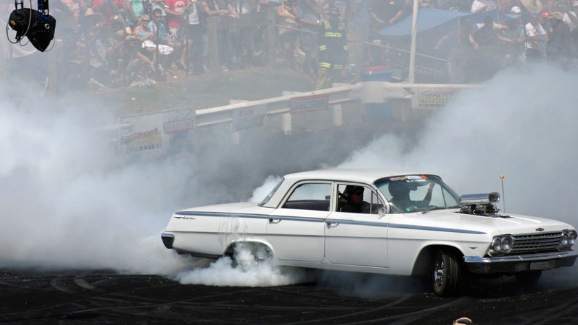 A white car does a burn-out at Summernats in Canberra, 2009
