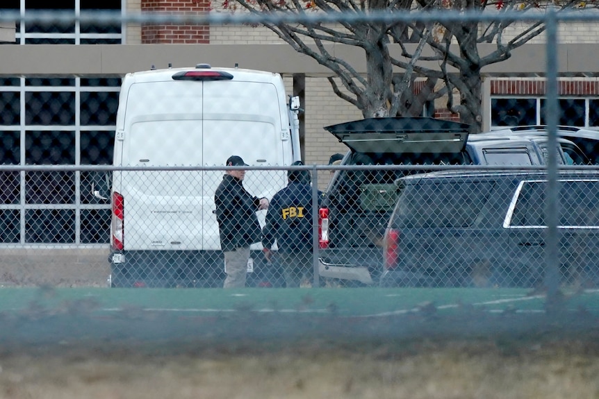 an ambulance is surrounded by police