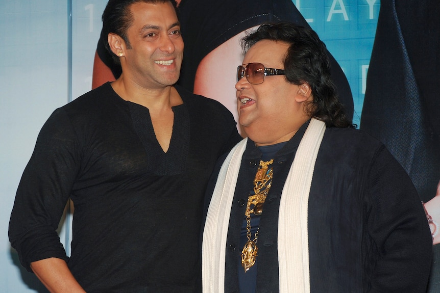 A picture of Bappi Lahiri standing next to another man 