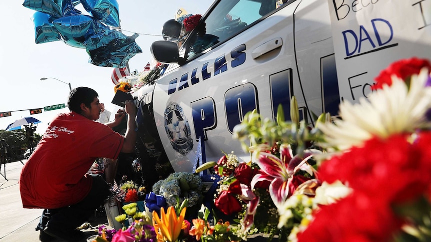 A growing memorial in front of the Dallas Police HQ