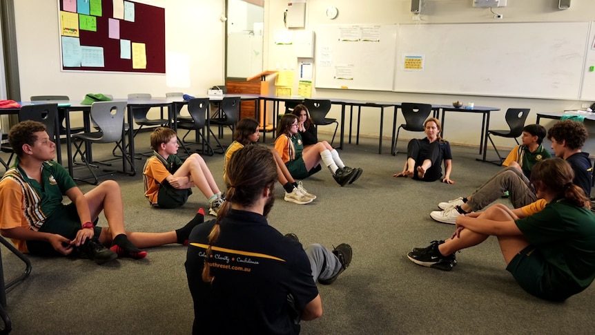 A circle of students sitting on the floor