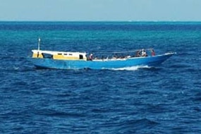 A boat carrying asylum seekers sails off Ashmore Island in 2010. (ACBP)