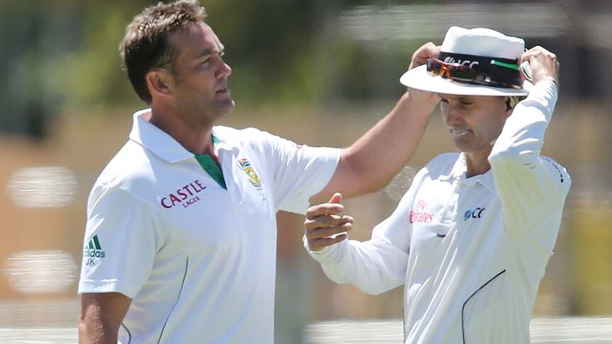 Jacques Kallis gets his sunglasses from umpire Billy Bowden