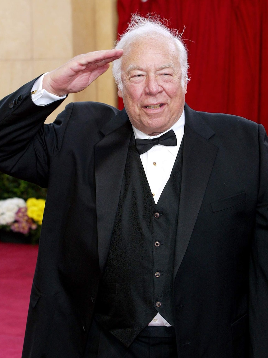 George Kennedy salutes on the Oscars red carpet.