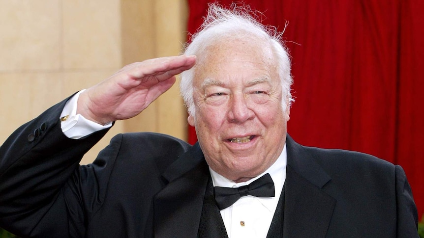 George Kennedy salutes on the Oscars red carpet.