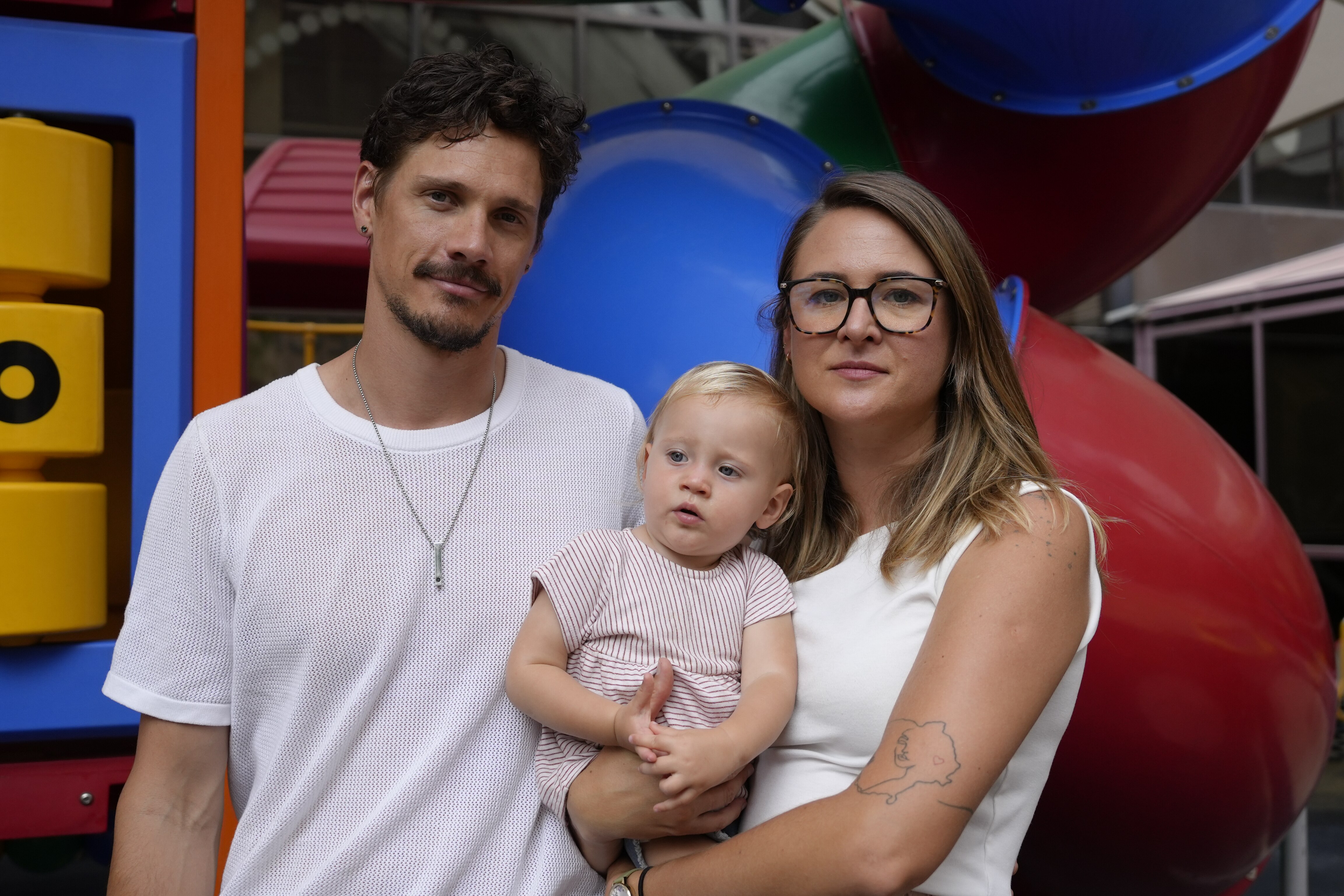 A mother and father with their daughter.