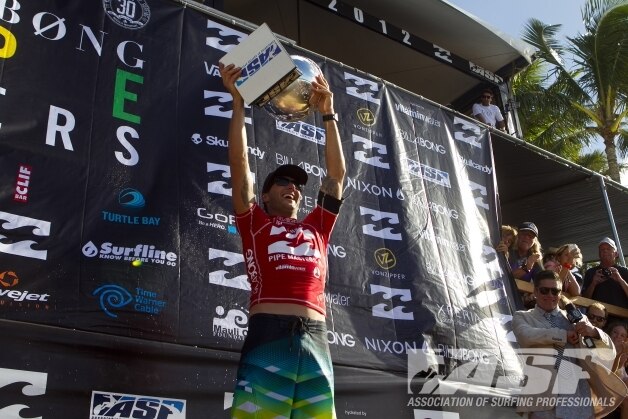 Joel Parkinson celebrates with the trophy after winning the Pipeline Masters and world surfing title.