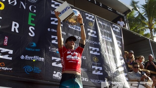 Joel Parkinson celebrates with the trophy after winning the Pipeline Masters and world surfing title.