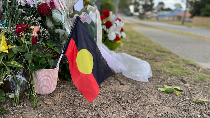 A floral memorial for Cassius Turvey set up by a tree in Middle Swan