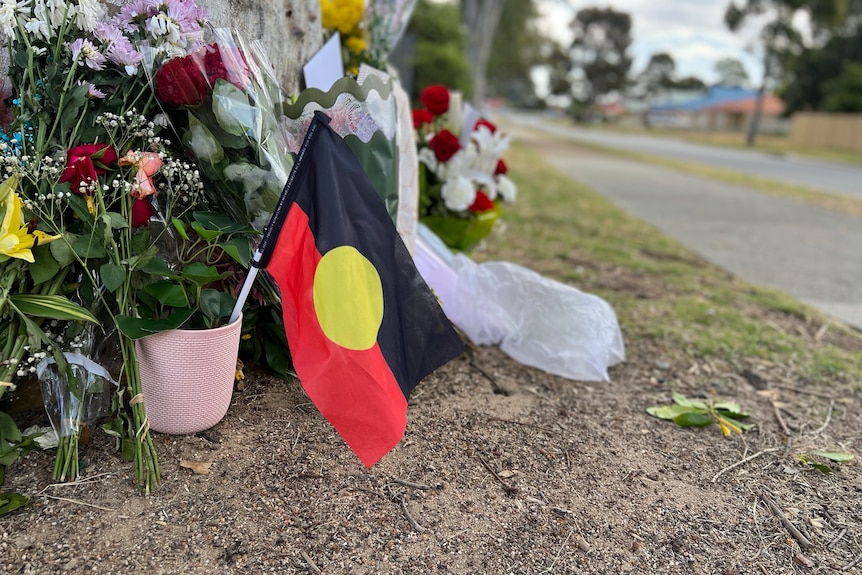 A floral memorial for Cassius Turvey set up by a tree in Middle Swan